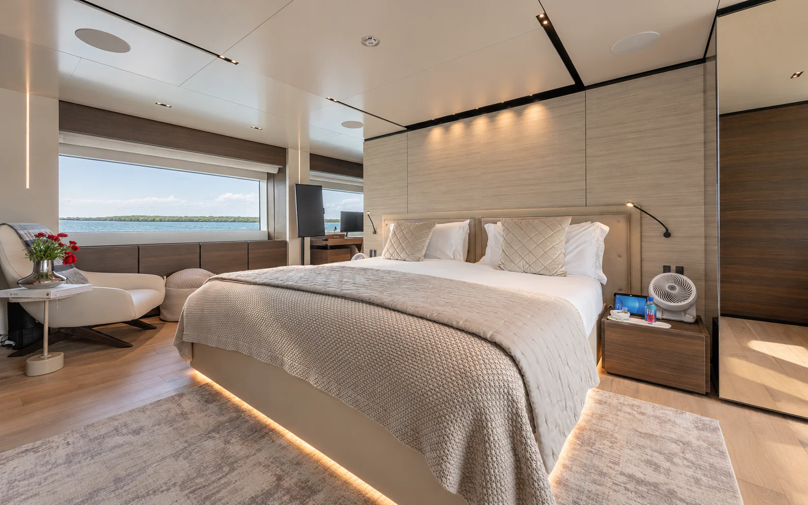 The owner's bed and upholstered headboard